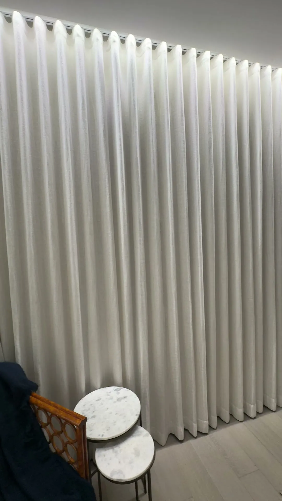 Full-height wave-fold drapery on a concealed track