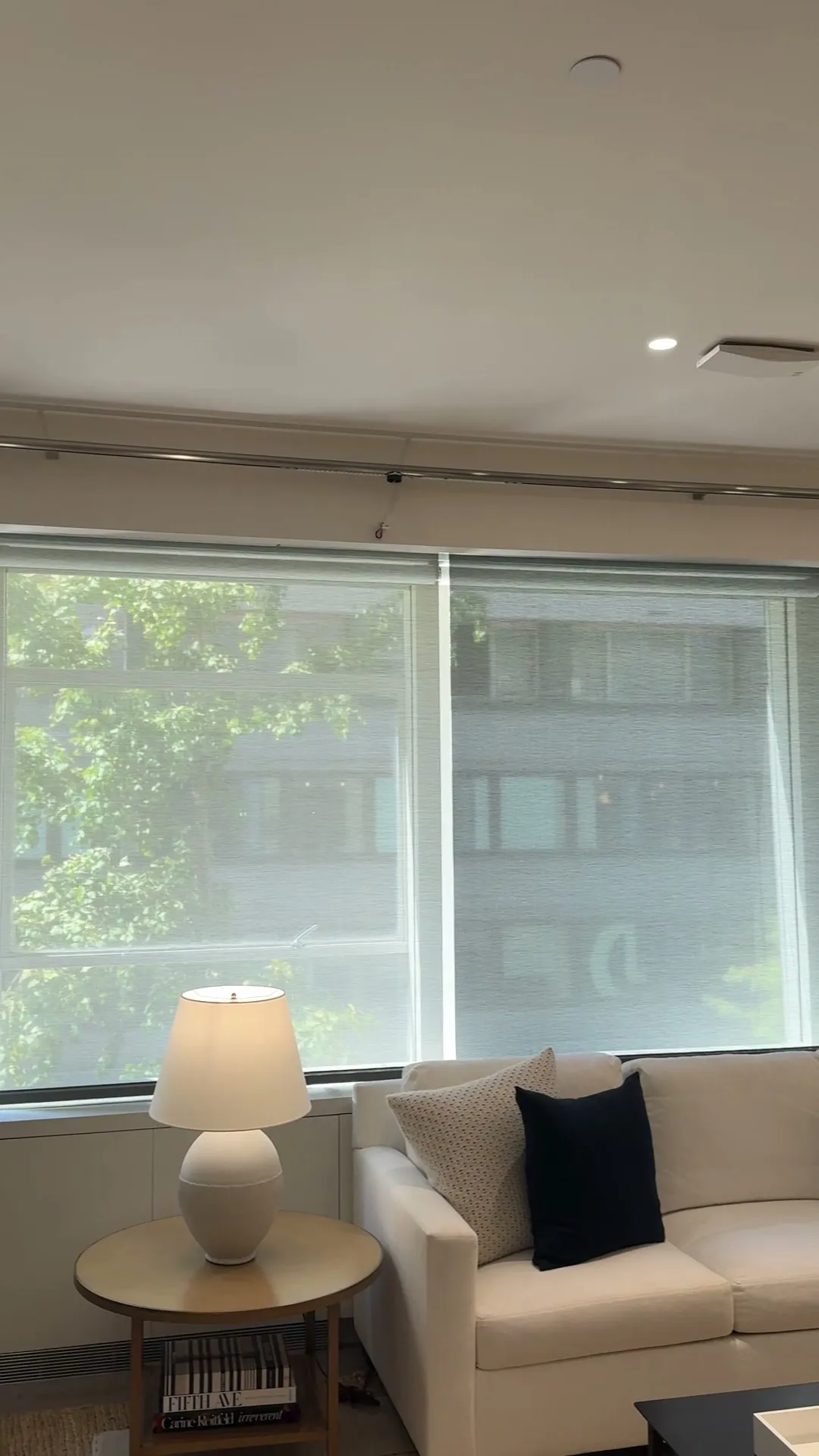 Motorized roller shades lowered in a New York living room