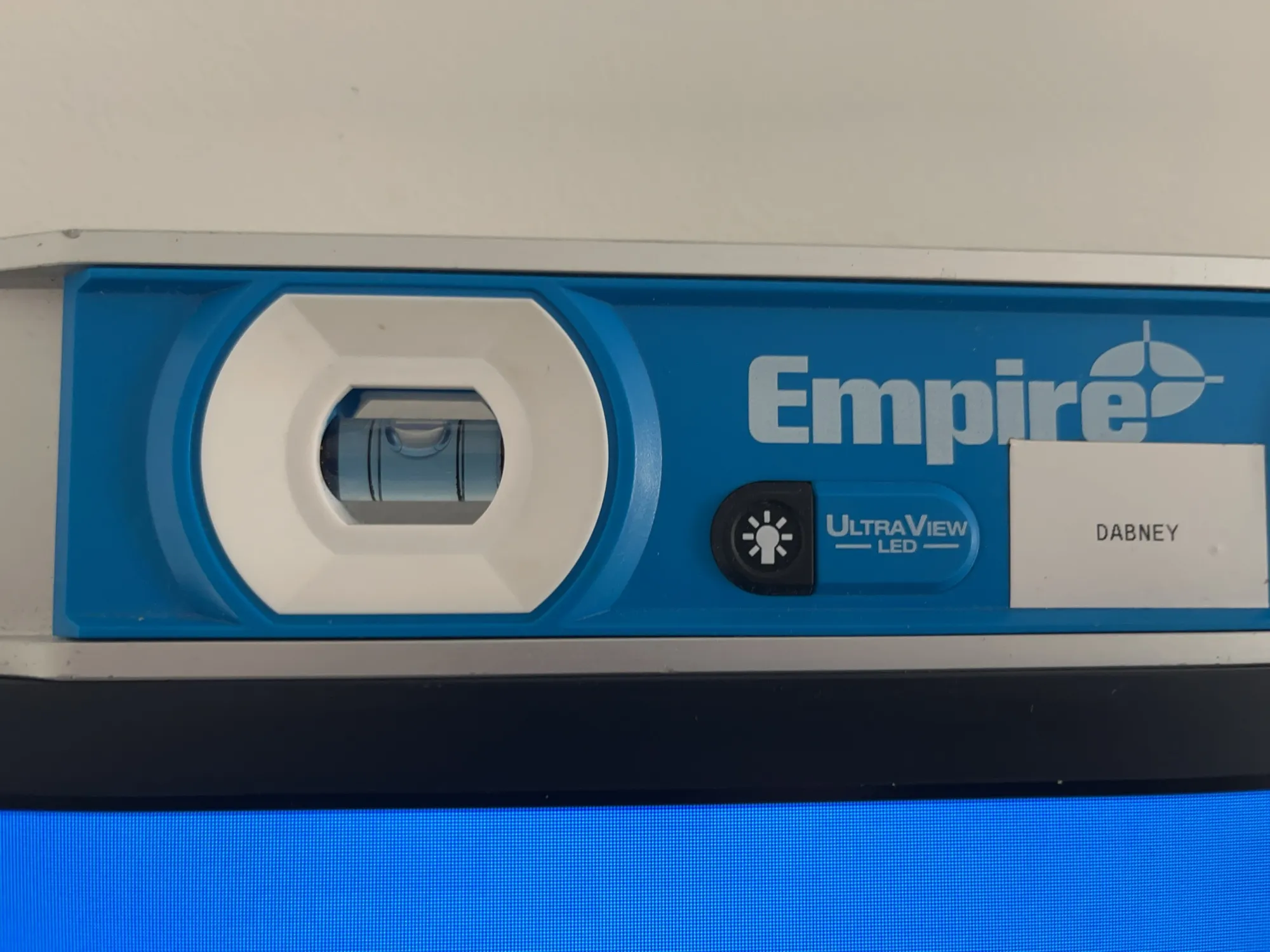 A level tool resting on top of a mounted TV.