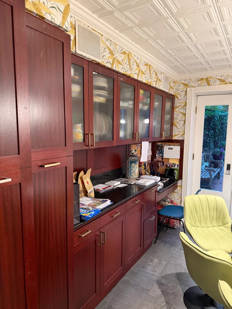 Two square speaker grilles are installed in the kitchen ceiling above the cabinetry.