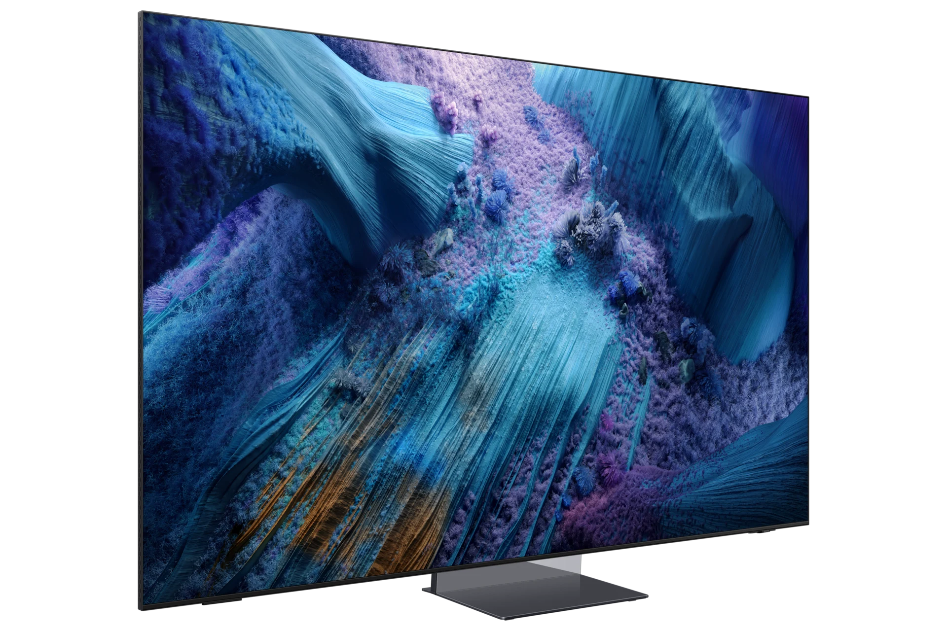Three-quarter angle view of the QN990F, showing its thin bezel and center pedestal stand against a blue and purple abstract screen image.