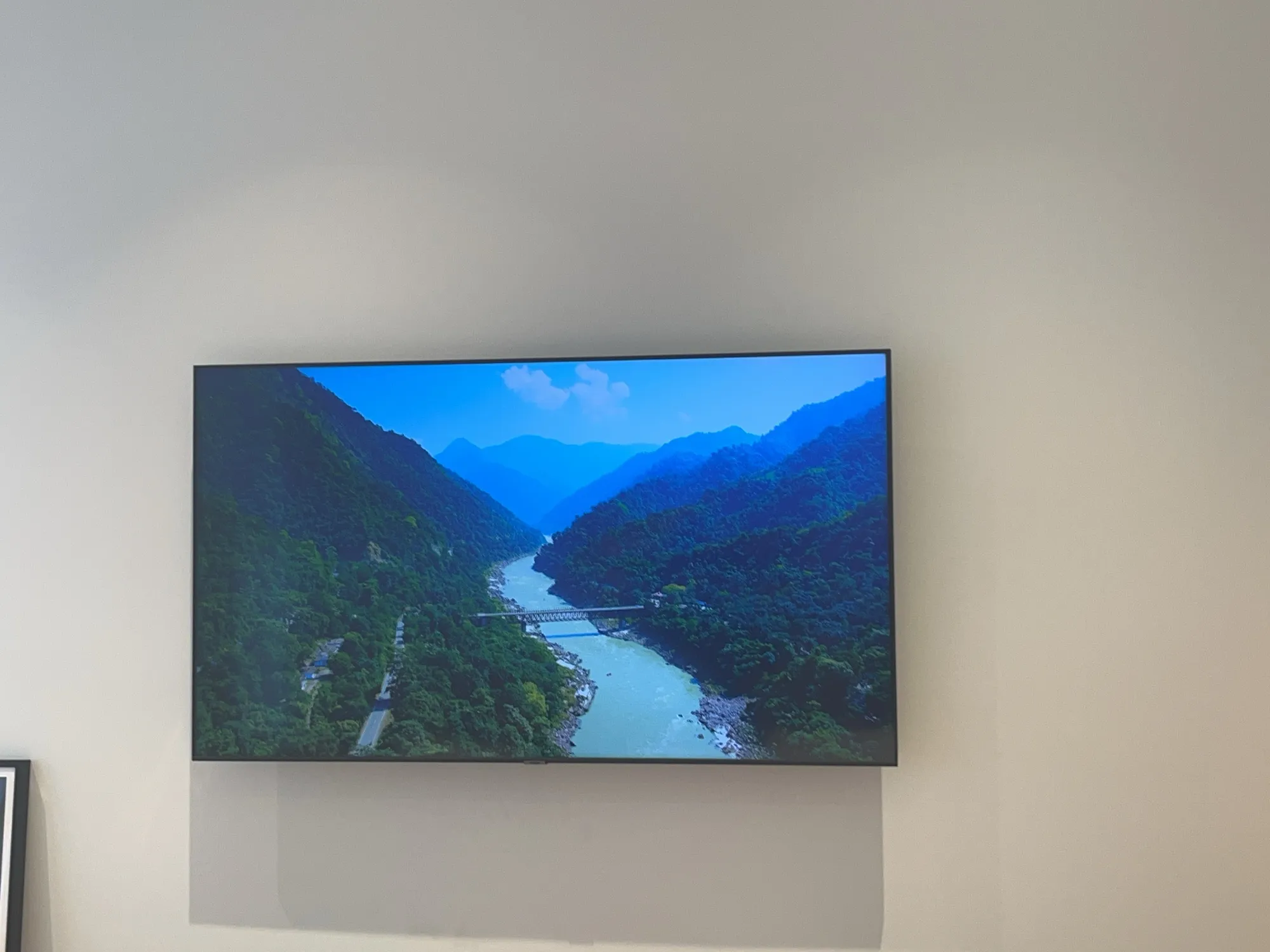 The wall-mounted living room TV from a slightly different front angle.