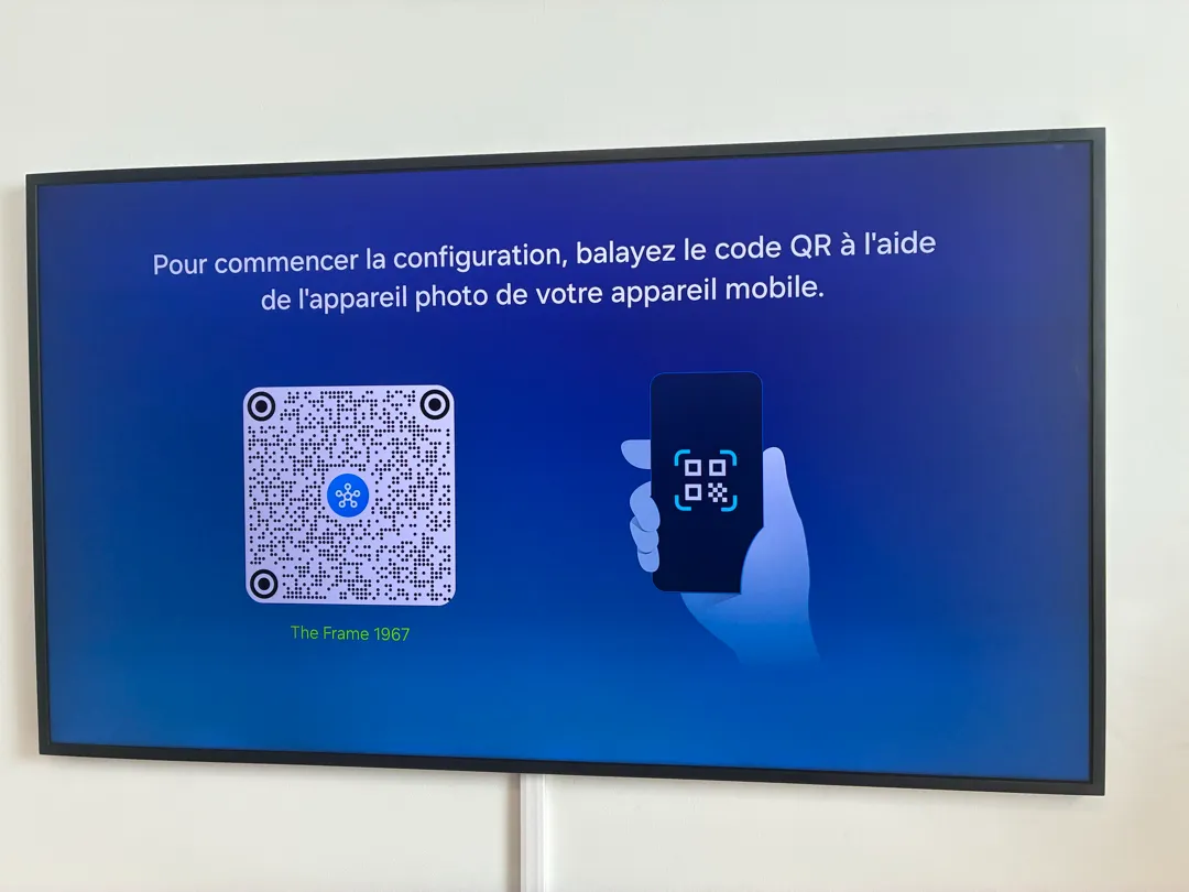 A wall-mounted TV with a white cord cover running down the wall below it.