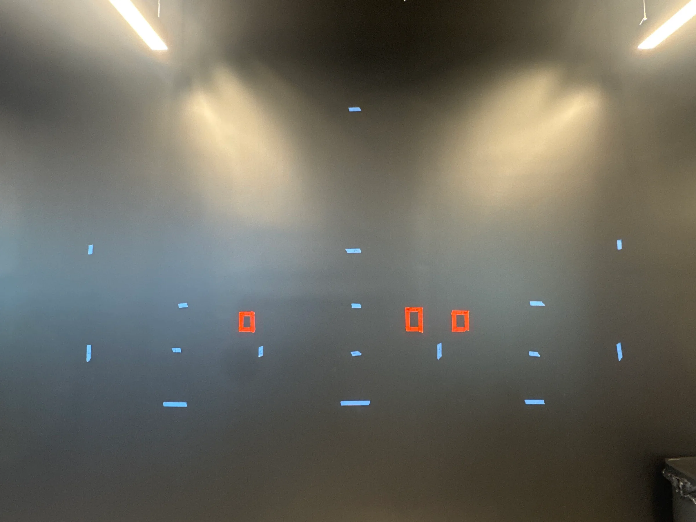 Measurements marked on a black wall before Video Wall mounting