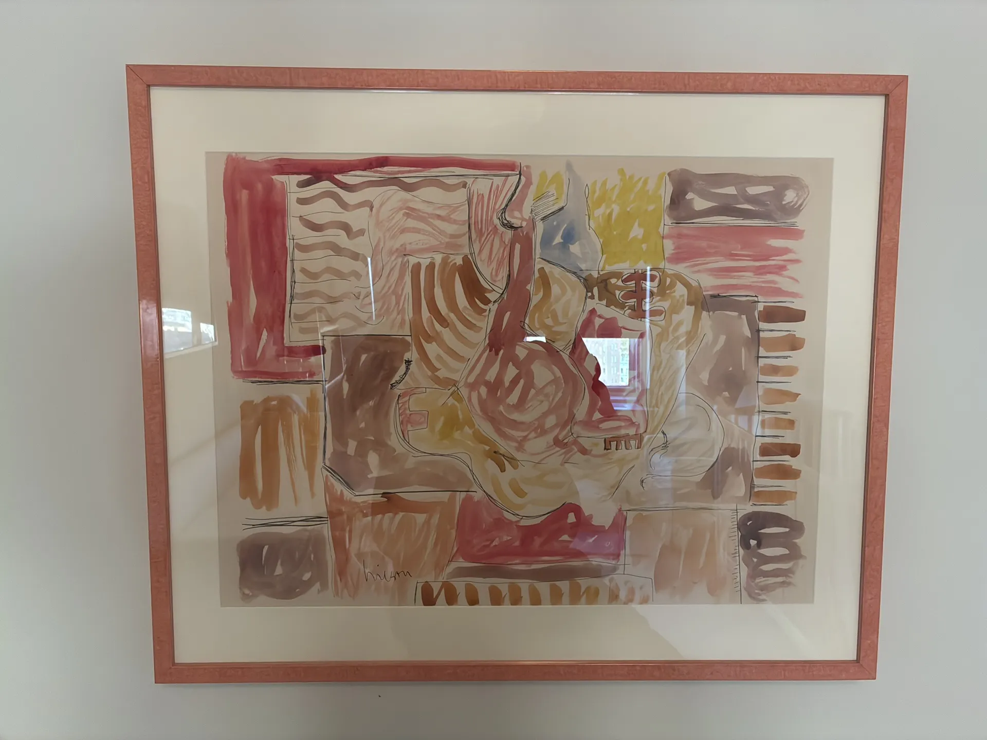 A pink-framed abstract watercolor hanging on a white wall.