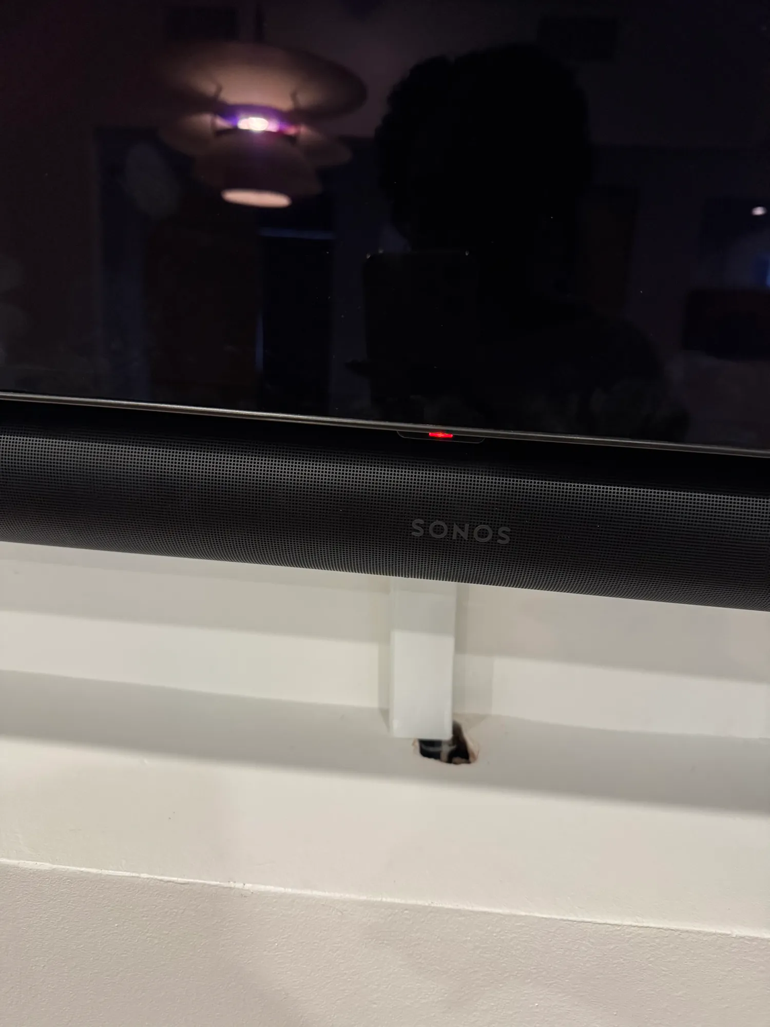 A close view of the Sonos soundbar under the office TV before the visit.