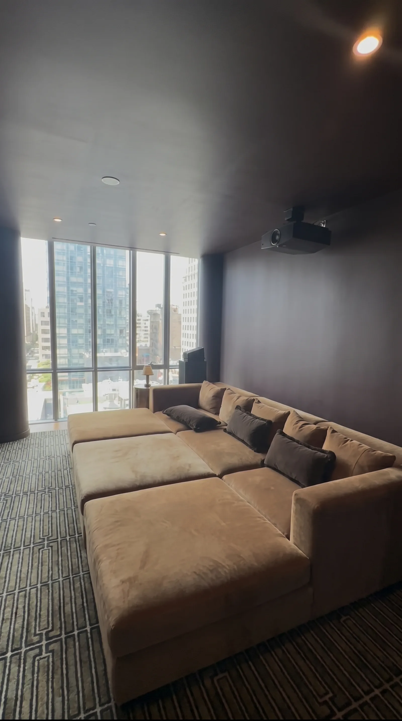 Ceiling projector home theatre with a city view
